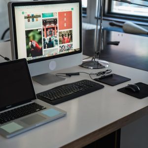 A sleek, modern office desk setup with computers and gadgets, perfect for productivity.