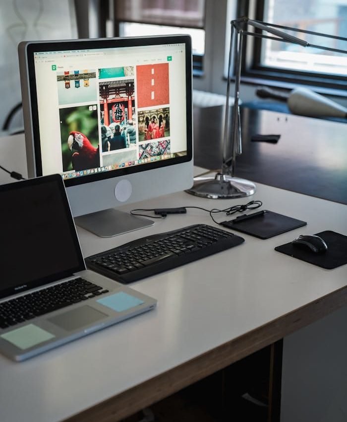 A sleek, modern office desk setup with computers and gadgets, perfect for productivity.